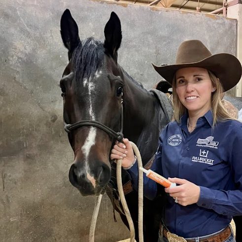 Professional Barrel Racer Ceri Ward giving her horse FullBucket probiotic paste. 